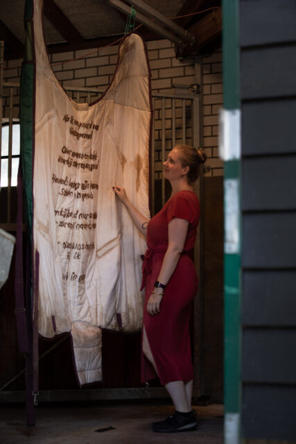 Artist Suzanne Vellema looking at the exhibited artwork named Voor Suus